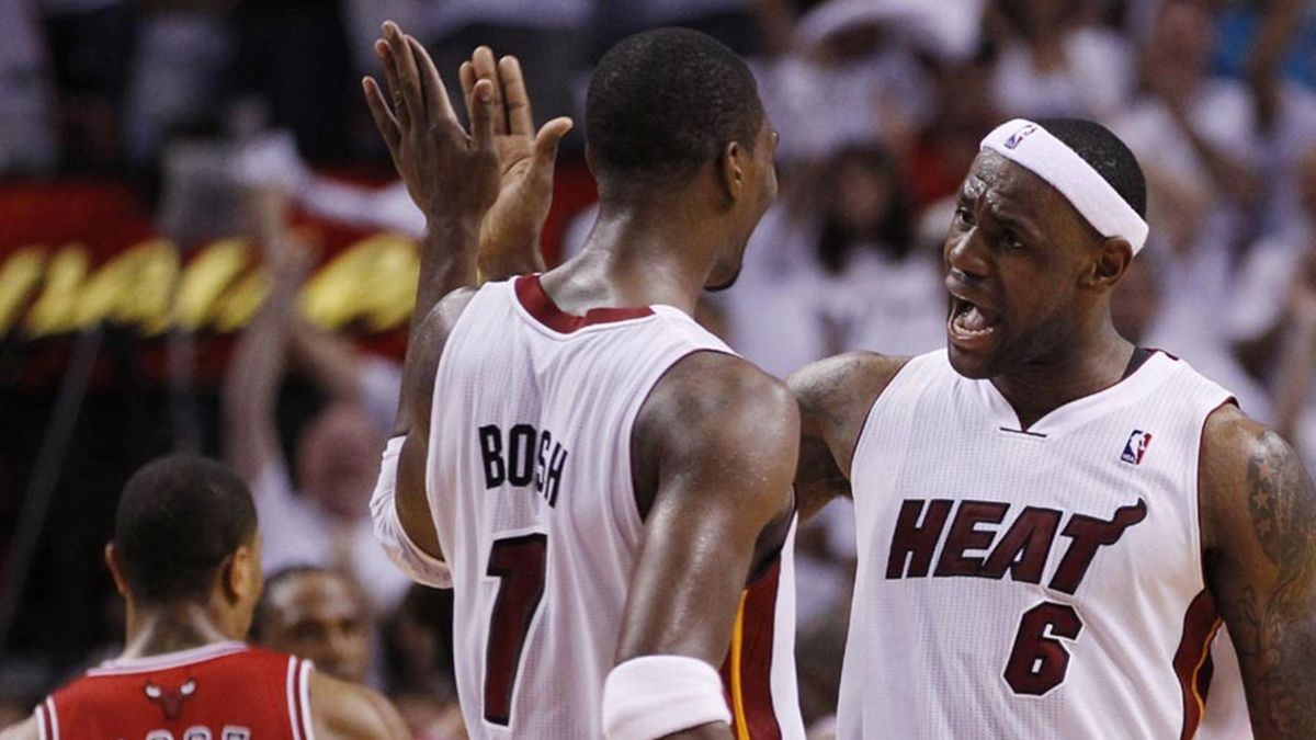 2010-11 NBA Miami Heat's LeBron James (R) celebrates with teammate Chris Bosh as Chicago Bulls' Derrick Rose walks away