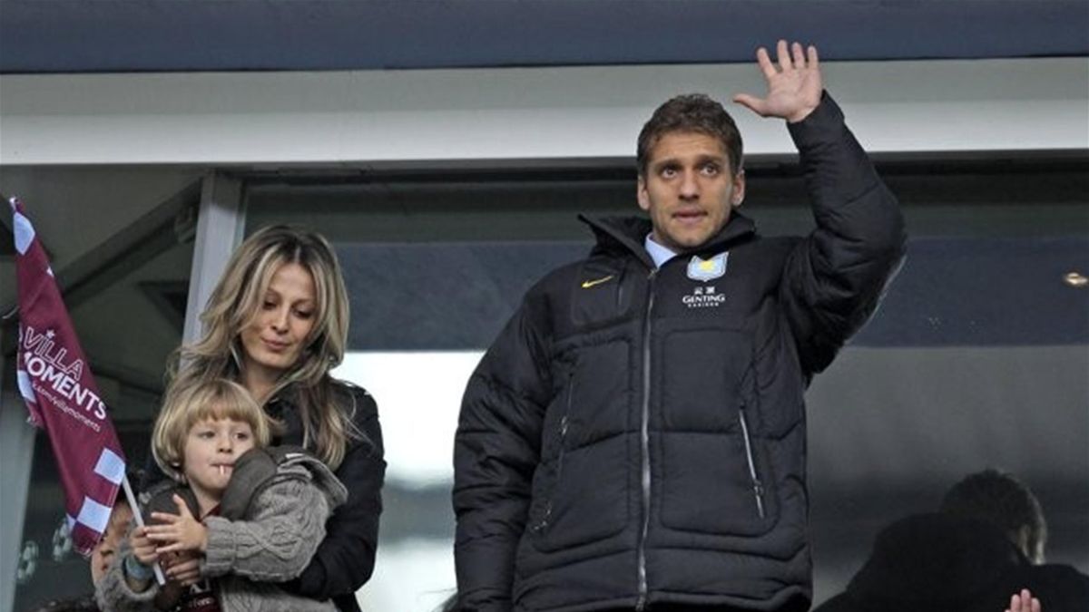 Aston Villa's captain, Bulgarian midfielder Stiliyan Petrov (R), who has been recently been diagnosed with acute leukaemia, attends the match and acknowledges the supporters before the English Premier League football match between Aston Villa and Chelsea 