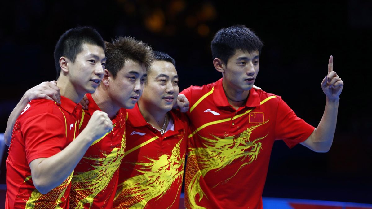 China's Zhang Jike (R) and team mates Wang Hao (2nd L), Ma Long (L) and coach Liu Guoliang celebrate their victory in their men's team gold medal table tennis match against South Korea at the ExCel venue during the London 2012 Olympic Games August 8, 2012