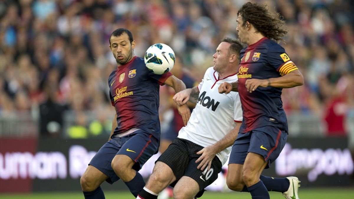 Manchester United's Wayne Rooney fights for the ball with Barcelona's Javier Mascherano and Carles Puyol during their friendly in Goteborg (Reuters)