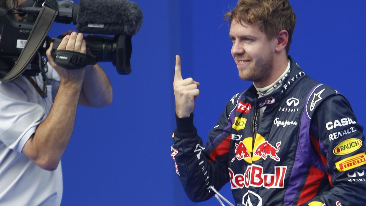 Red Bull Formula One driver Sebastian Vettel of Germany celebrates taking the pole position after the qualifying session for the Malaysian F1 Grand Prix at Sepang International Circuit outside Kuala Lumpur, March 23, 2013 (Reuters)