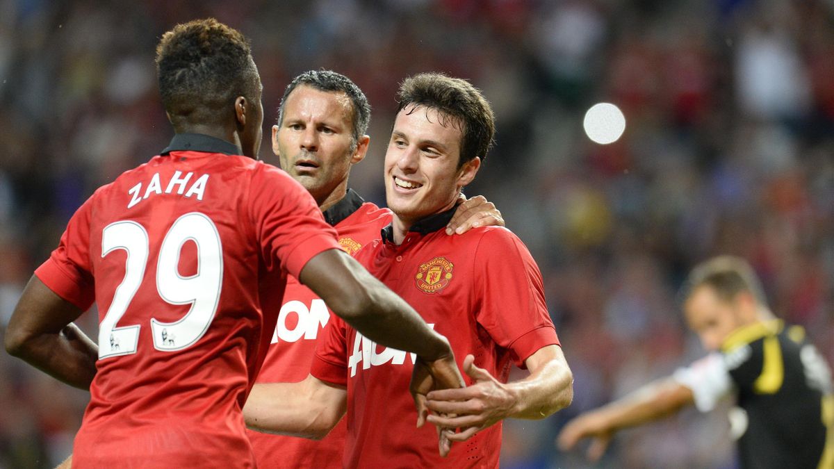  Manchester United's Chilean striker Angelo Henriquez (R) celebrates teammate midfielder Ryan Giggs (C) and midfielder Wilfried Zaha (L) after scoring during the friendly football match AIK vs Manchester United (AFP)