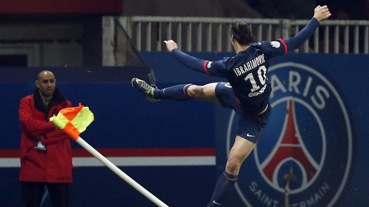 Paris St Germain's Zlatan Ibrahimovic (R) jumps and kicks a corner flag as he celebrates scoring against FC Nantes during their French Ligue 1 soccer match at the Parc des Princes Stadium in Paris January 19, 2014 (Reuters)