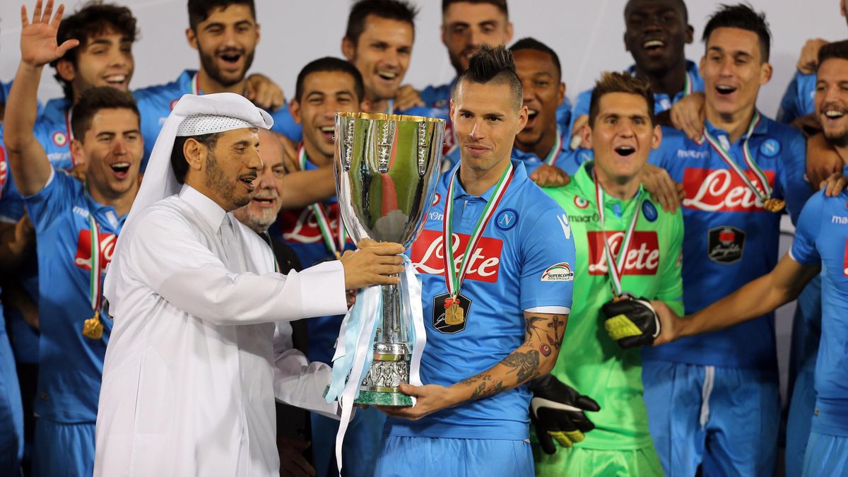 Qatar's Prime Minister, Sheikh Abdullah bin Nasser bin Khalifa al-Thani (L) presents Napoli's Slovak midfielder and captain Marek Hamsik (C) with Italian Super Cup trophy.