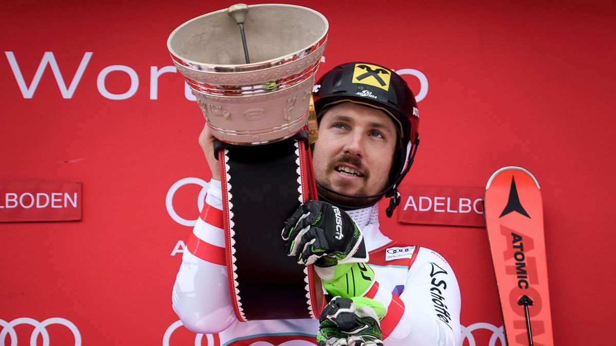 Marcel Hirscher rings a bell on the podium during the trophy ceremony after competing in the Men's slalom race at the FIS Alpine Skiing World Cup on January 7, 2018 in Adelboden