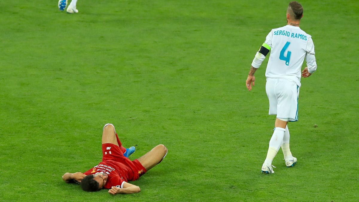 Mohamed Salah, left, lies injured after a challenge from Sergio Ramos
