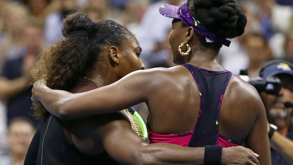 Serena and Venus Williams embrace at the end of their US Open clash