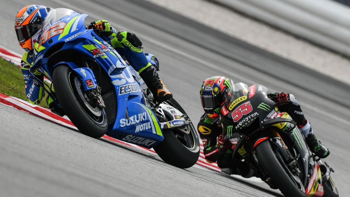 Spanish rider Alex Rins (L) and Monster Yamaha Tech 3's Malaysian rider Hafizh Syahrin (R) take a corner during the second practice session of the Malaysia MotoGP at the Sepang International Circuit in Sepang on November 2, 2018.