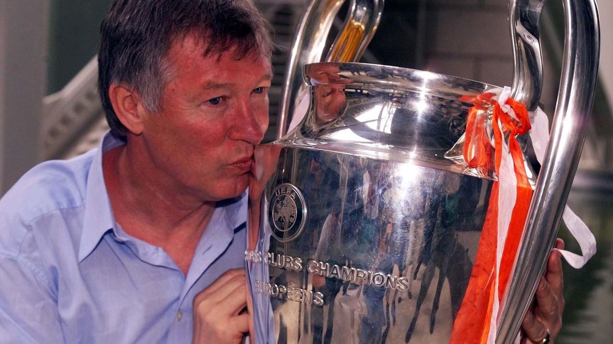 Sir Alex Ferguson celebrates with the Champions League trophy in 1999
