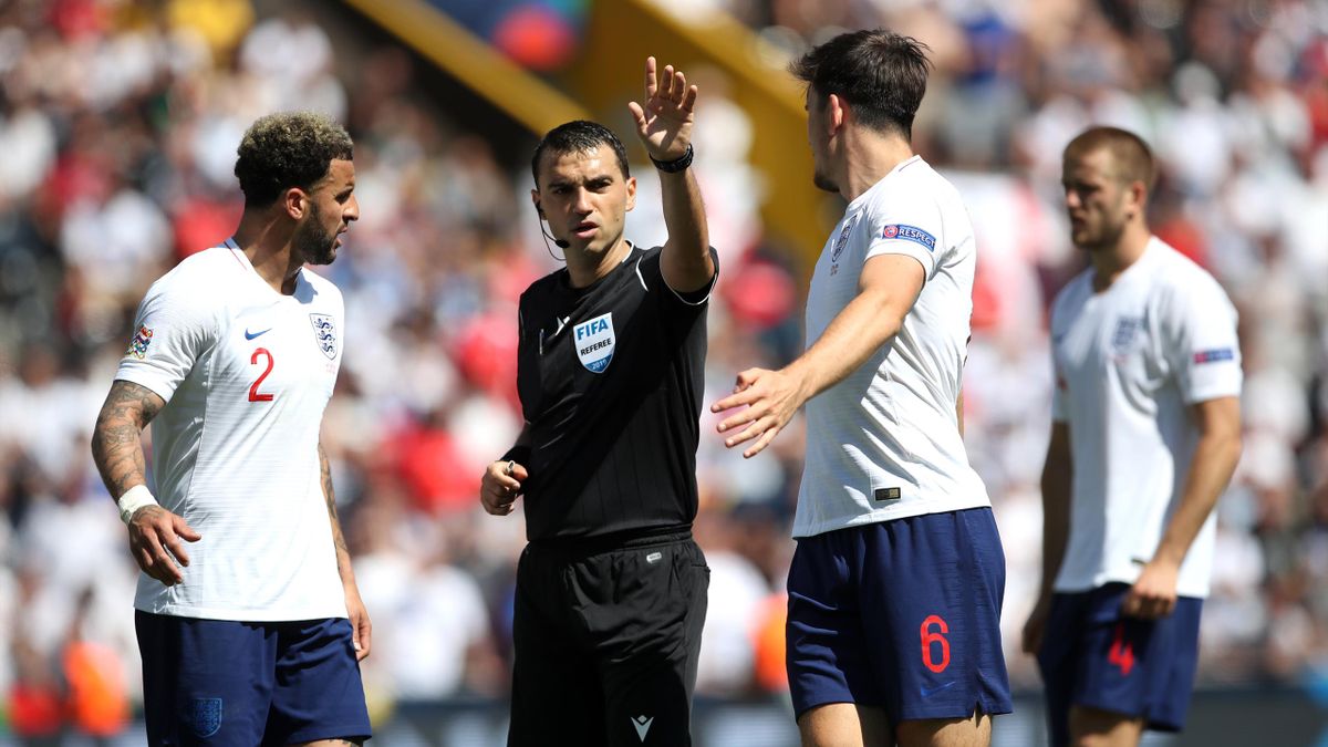 Harry Maguire and Kyle Walker exchange words with match referee Ovidiu Hategan