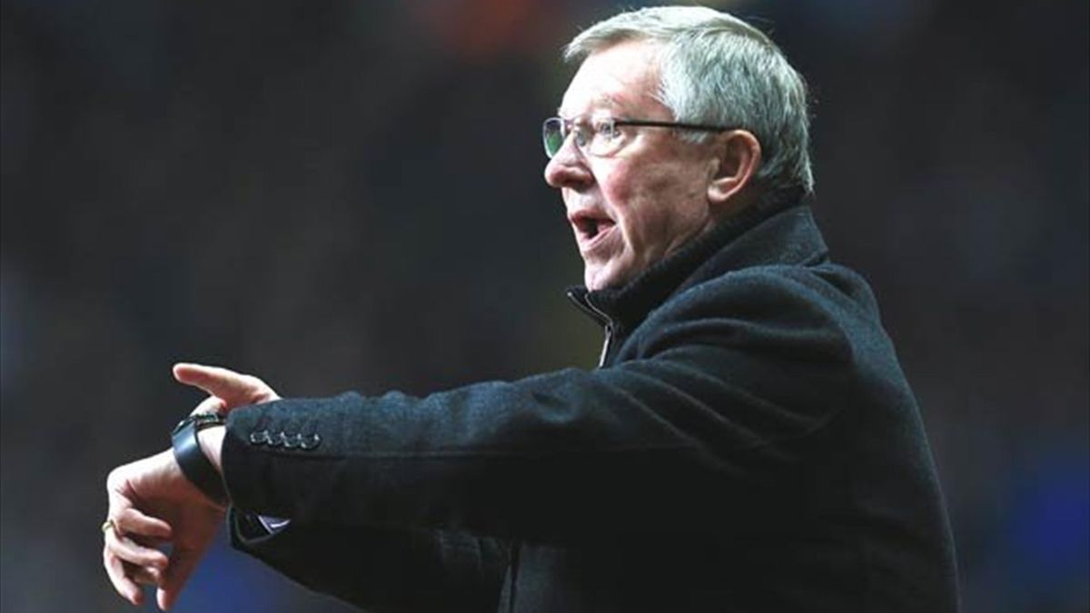 Sir Alex Ferguson points at his watch (PA Sport)