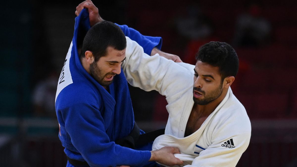 Israel's Sagi Muki (white) and Russia's Mikhail Igolnikov compete in the judo mixed team's bronze medal B bout during the Tokyo 2020 Olympic Games