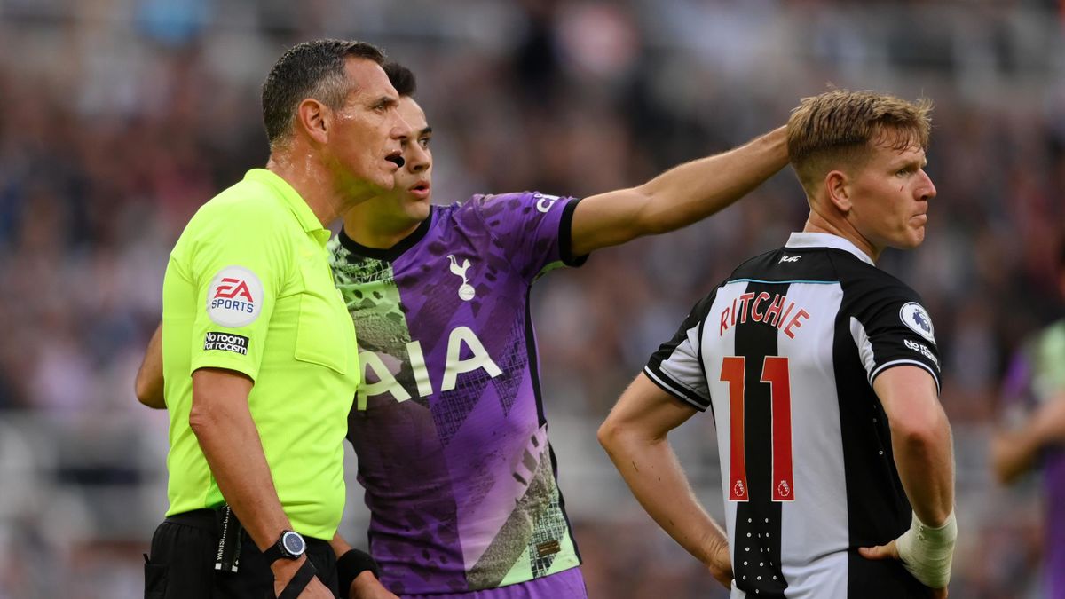 Match Referee, Andre Marriner looks on as Sergio Reguilon of Tottenham Hotspur points out a potential issue in the stand during the Premier League match between Newcastle United and Tottenham Hotspur at St. James' Park
