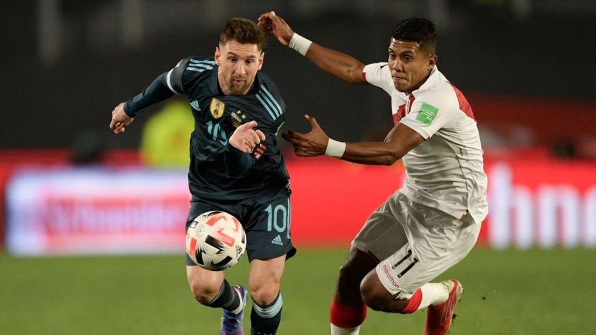 Argentina's Lionel Messi (L) and Peru's Raziel Garcia vie for the ball during their South American qualification football match for the FIFA World Cup Qatar 2022, at the Monumental stadium in Buenos Aires, on October 14, 2021