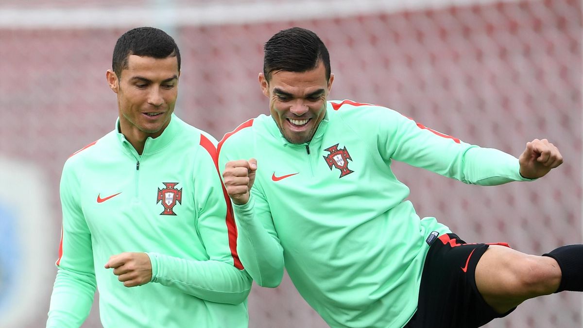 Cristiano Ronaldo of Portugal shares a joke with Pepe during a training session at Stadium Rubin on June 27, 2017 in Kazan, Russia.