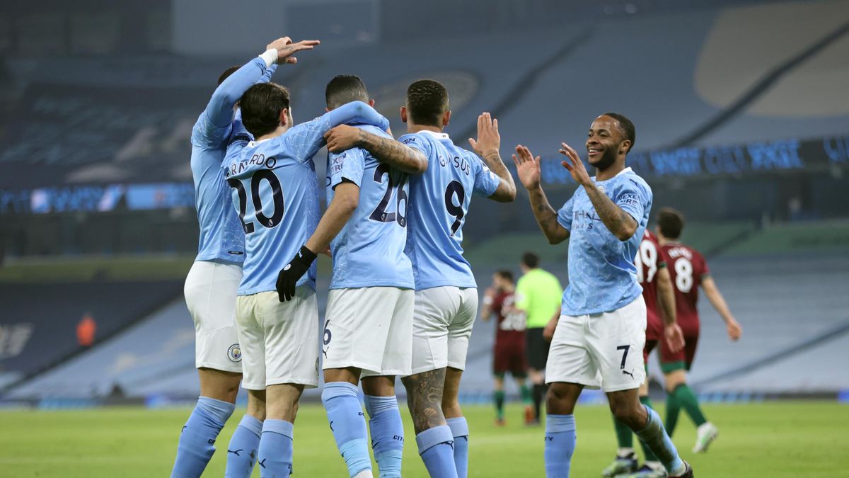 Players of Manchester City celebrate their first goal, which was an own goal scored by Leander Dendoncker of Wolverhampton Wanderers (not pictured) during the Premier League match between Manchester City and Wolverhampton Wanderers at Etihad Stadium on Ma
