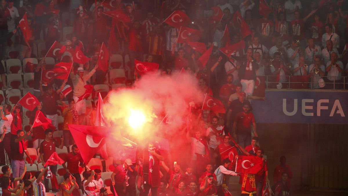 Turkey fans light a flare