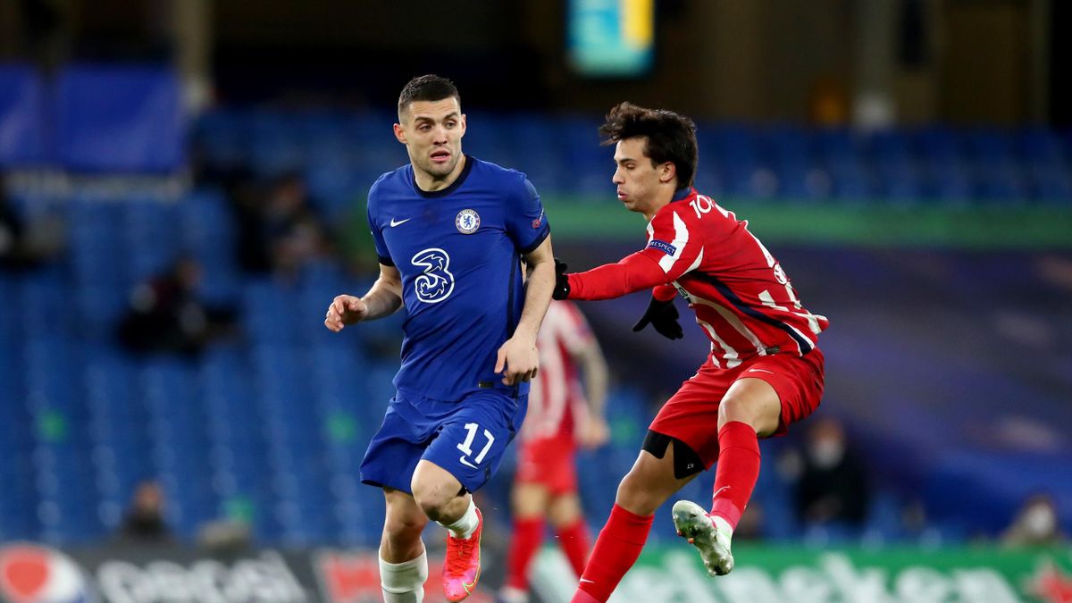 : Mateo Kovacic of Chelsea in action with Joao Felix of Atletico Madrid during the UEFA Champions League Round of 16 match between Chelsea FC and Atletico Madrid at Stamford Bridge on March 17, 2021 in London, United Kingdom