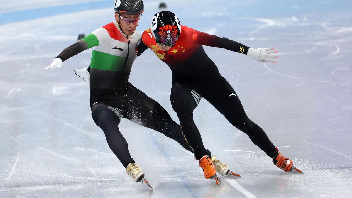 Ziwei Ren of Team China and Shaoang Liu of Team Hungary collide as they cross the finish line during the Men's 1000m Final A on day three of the Beijing 2022 Winter Olympic Games
