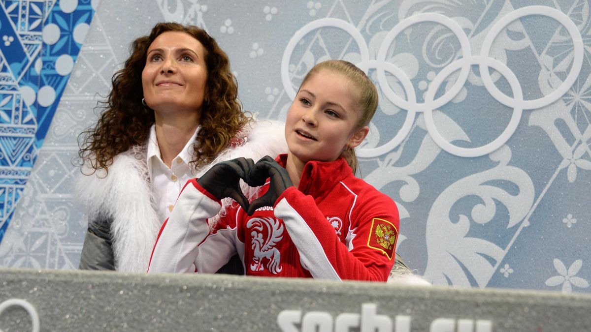 Russia's Julia Lipnitskaia (R) and her coach Eteri Tutberidze wait for her marks in the kiss and cry zone during the Women's Figure Skating Free Program at the Iceberg Skating Palace during the Sochi Winter Olympics on February 20, 2014.