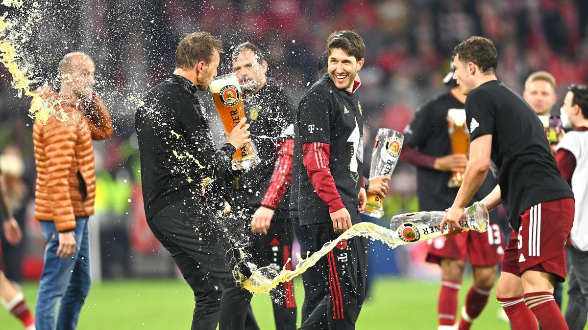 Julian Nagelsmann of Bayern Munich is showered with beer, April 23, 2022