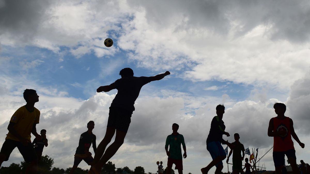 In this picture taken on July 19, 2018, Rohingya refugee children play football at the Kutupalong refugee camp in Ukhia. - The World Cup may be over but passion for the game burns bright in the world's largest refugee camp, where Brazil and Argentina flag
