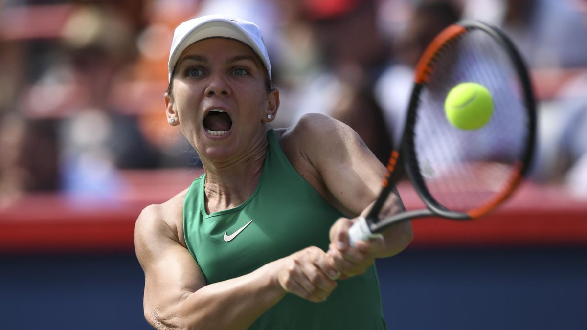 Simona Halep of Romania hits a return against Sloane Stephens in the final during day seven of the Rogers Cup at IGA Stadium on August 12, 2018 in Montreal, Quebec, Canada