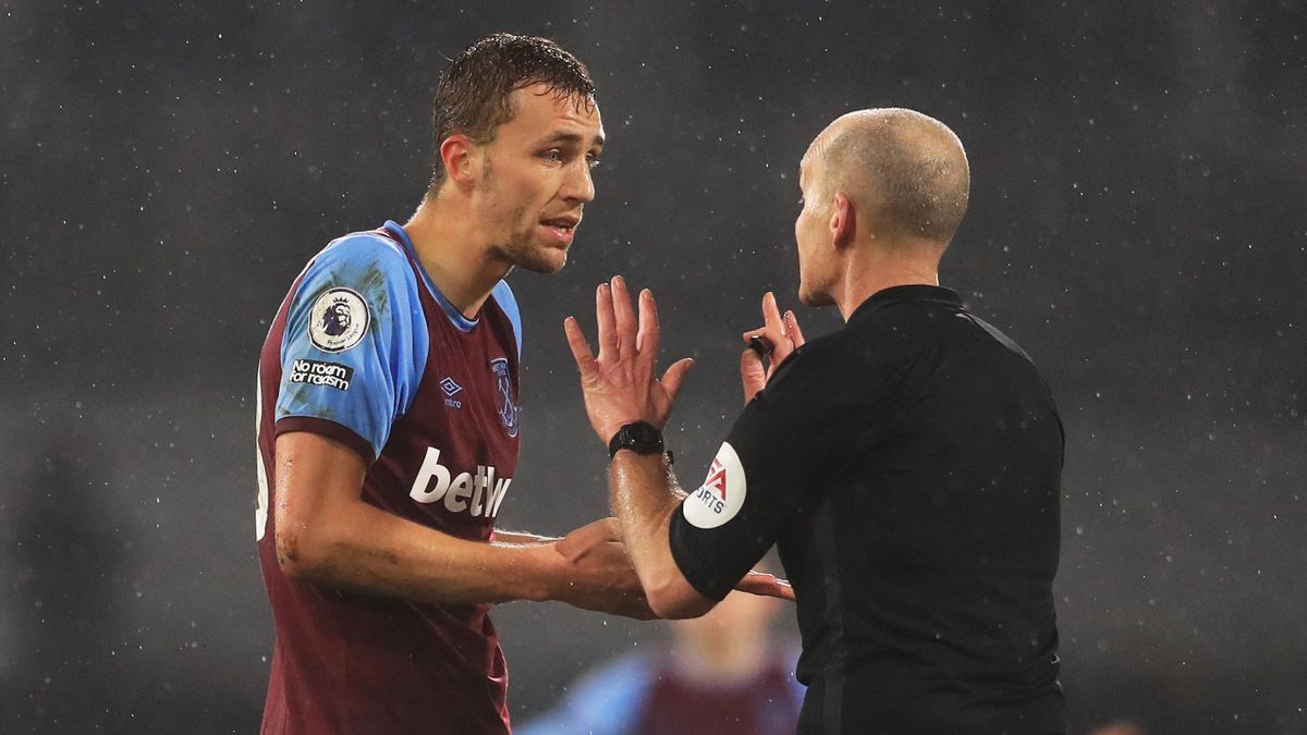 Tomas Soucek of West Ham appeals to match referee Mike Dean after being shown a red card during the Premier League match between Fulham and West Ham United at Craven Cottage on February 06, 2021 in London, England.