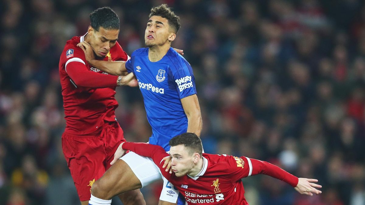 Dominic Calvert-Lewin of Everton jumps between Virgil van Dijk and Andy Robertson of Liverpool