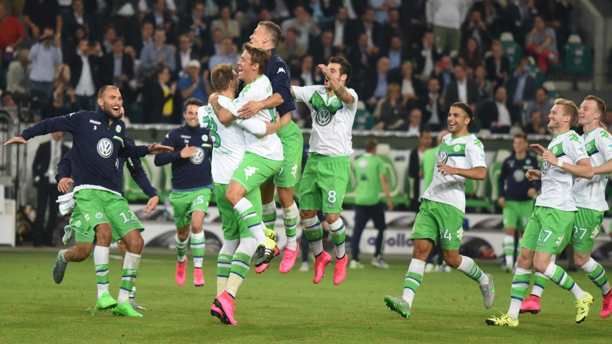 VfL Wolfsburg players celebrate after defeating Bayern Munich in a penalty shoot-out to win the German Supercup