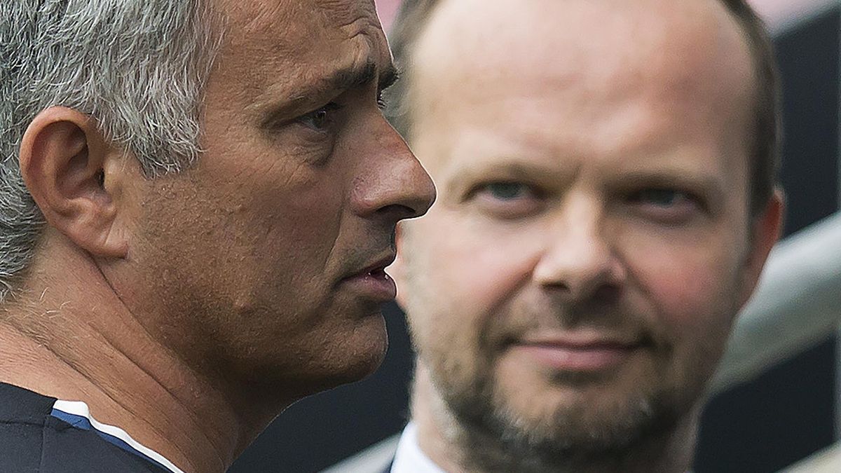 Manchester United's executive vice-chairman Ed Woodward (R) listens as Manchester United's Portuguese manager Jose Mourinho talks