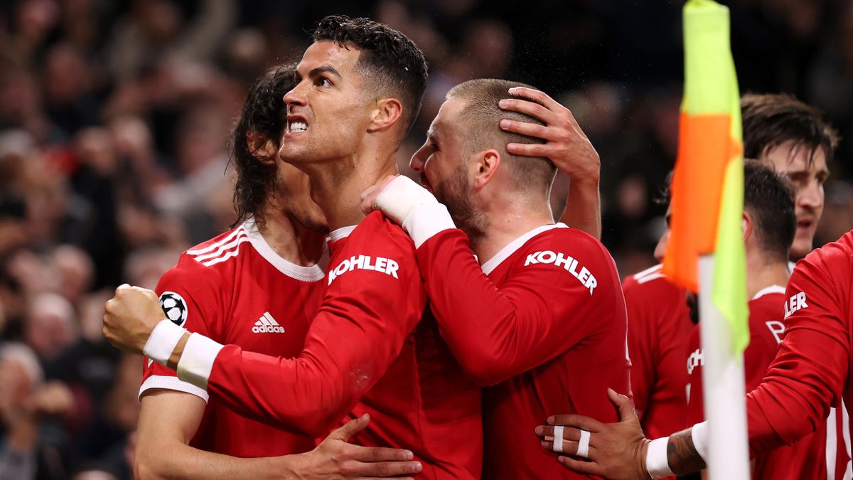 MANCHESTER, ENGLAND - OCTOBER 20: Cristiano Ronaldo of Manchester United celebrates with teammates Luke Shaw and Edinson Cavani after scoring their side's third goal during the UEFA Champions League group F match between Manchester United and Atalanta at