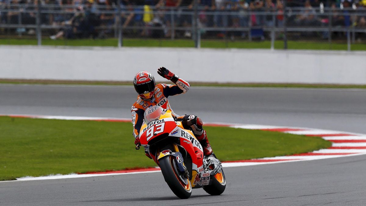 Honda MotoGP rider Marc Marquez of Spain waves after the qualifying session for the British Grand Prix at the Silverstone Race Circuit, Britain August 29, 2015