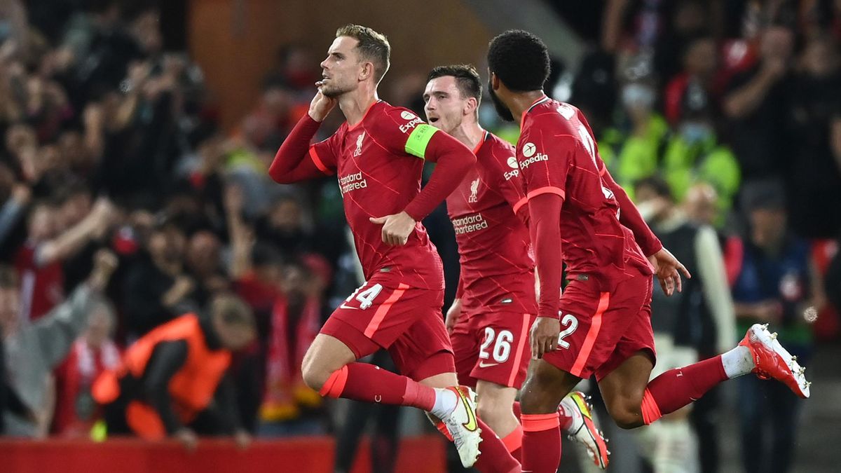 LIVERPOOL, ENGLAND - SEPTEMBER 15: Jordan Henderson of Liverpool celebrates with teammates Joe Gomez and Andrew Robertson after scoring their side's third goal during the UEFA Champions League group B match between Liverpool FC and AC Milan at Anfield on