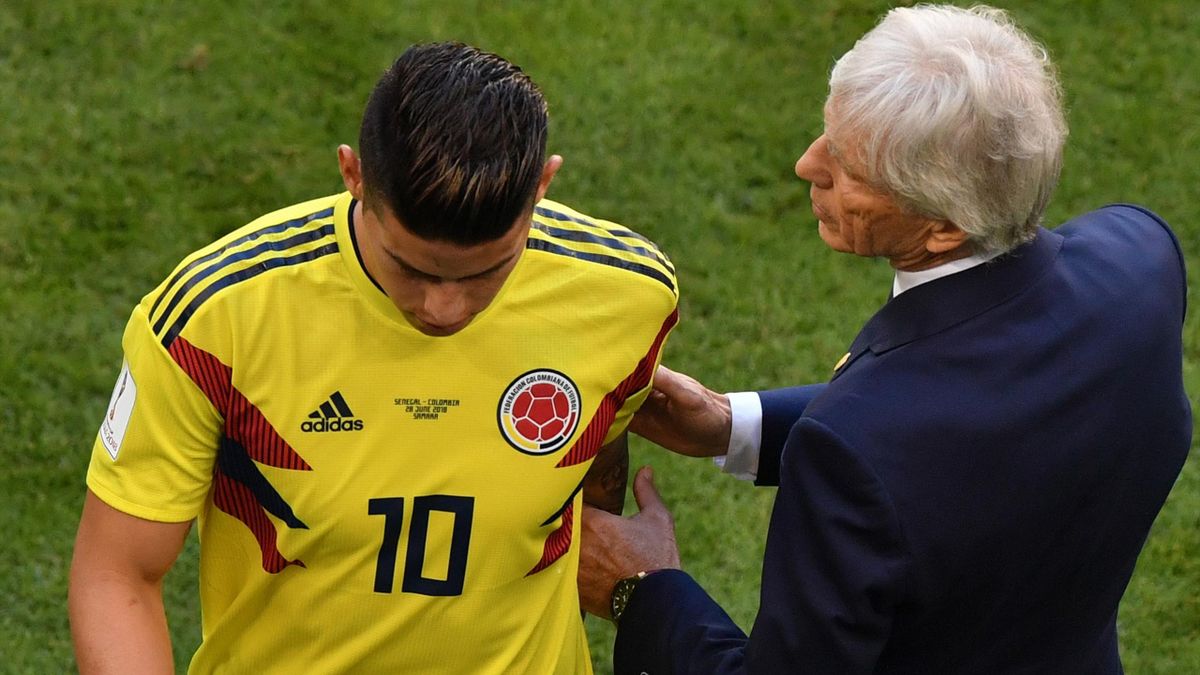 Colombia's midfielder James Rodriguez leaves the football pitch due to an injury as he is conforted by Colombia's coach Jose Pekerman (R) during the Russia 2018 World Cup Group H football match between Senegal and Colombia.