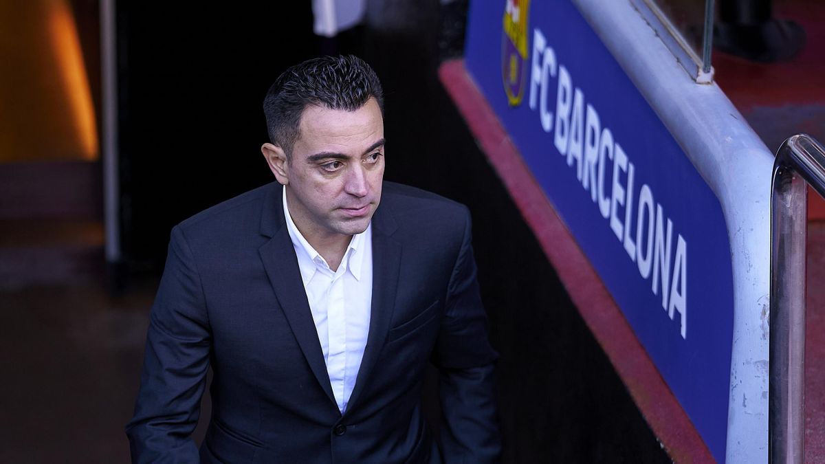New FC Barcelona Head Coach Xavi Hernandez comes onto the pitch for a photo during a press conference at Camp Nou on November 08, 2021 in Barcelona, Spain.