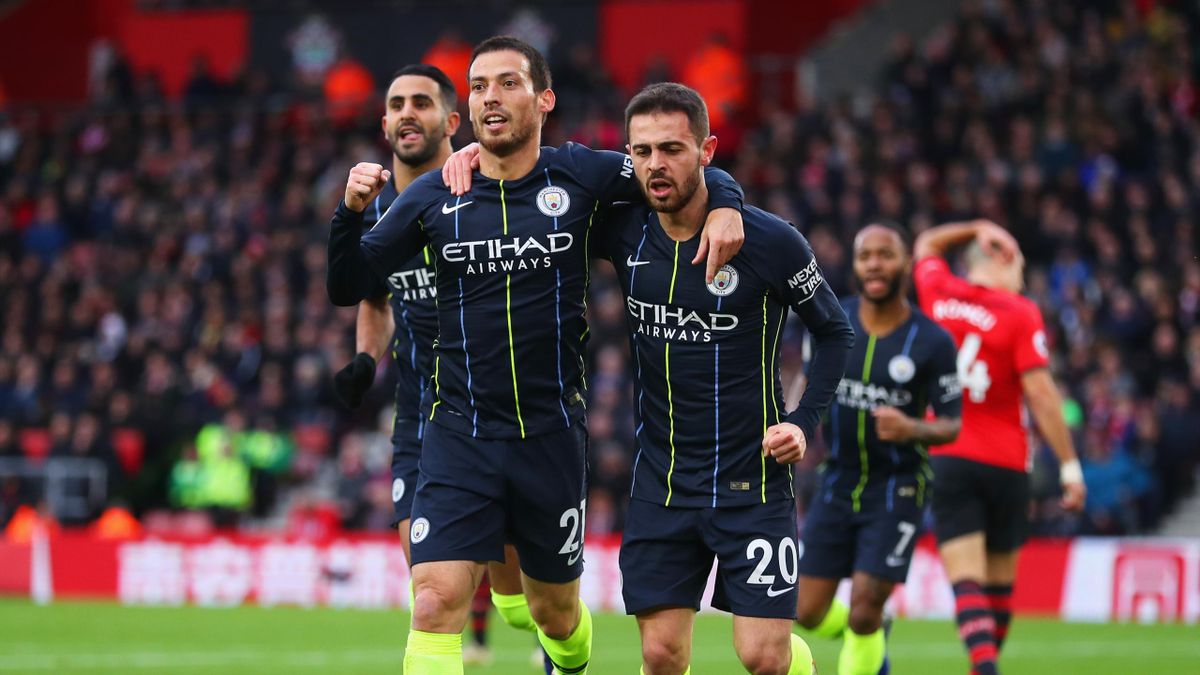 David Silva of Manchester City (21) celebrates after scoring his team's first goal with team mates Bernardo Silva and Riyad Mahrez of Manchester City during the Premier League match between Southampton FC and Manchester City at St Mary's Stadium on Decemb