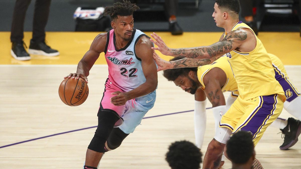 Jimmy Butler #22 of the Miami Heat handles the ball guarded by Kyle Kuzma #0 of the Los Angeles Lakers at Staples Center on February 20,