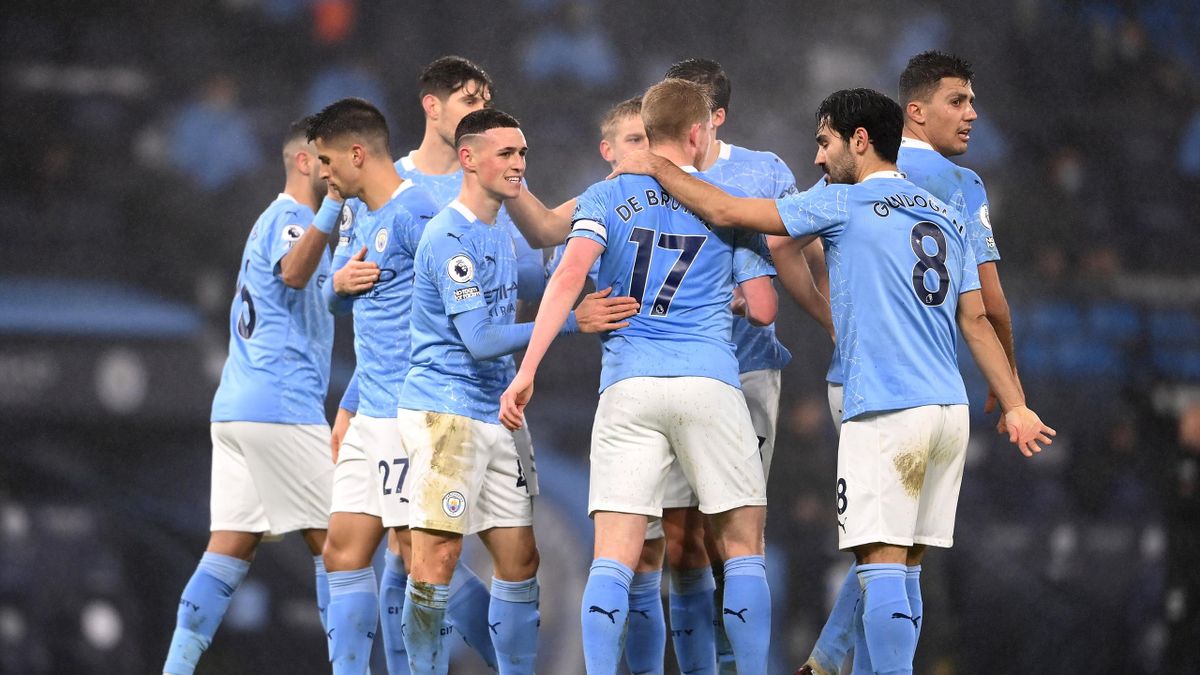 Phil Foden of Manchester City celebrates with teammates Kevin De Bruyne, Ilkay Guendogan and Rodrigo after scoring their team's first goal during the Premier League match between Manchester City and Brighton & Hove Albion at Etihad Stadium