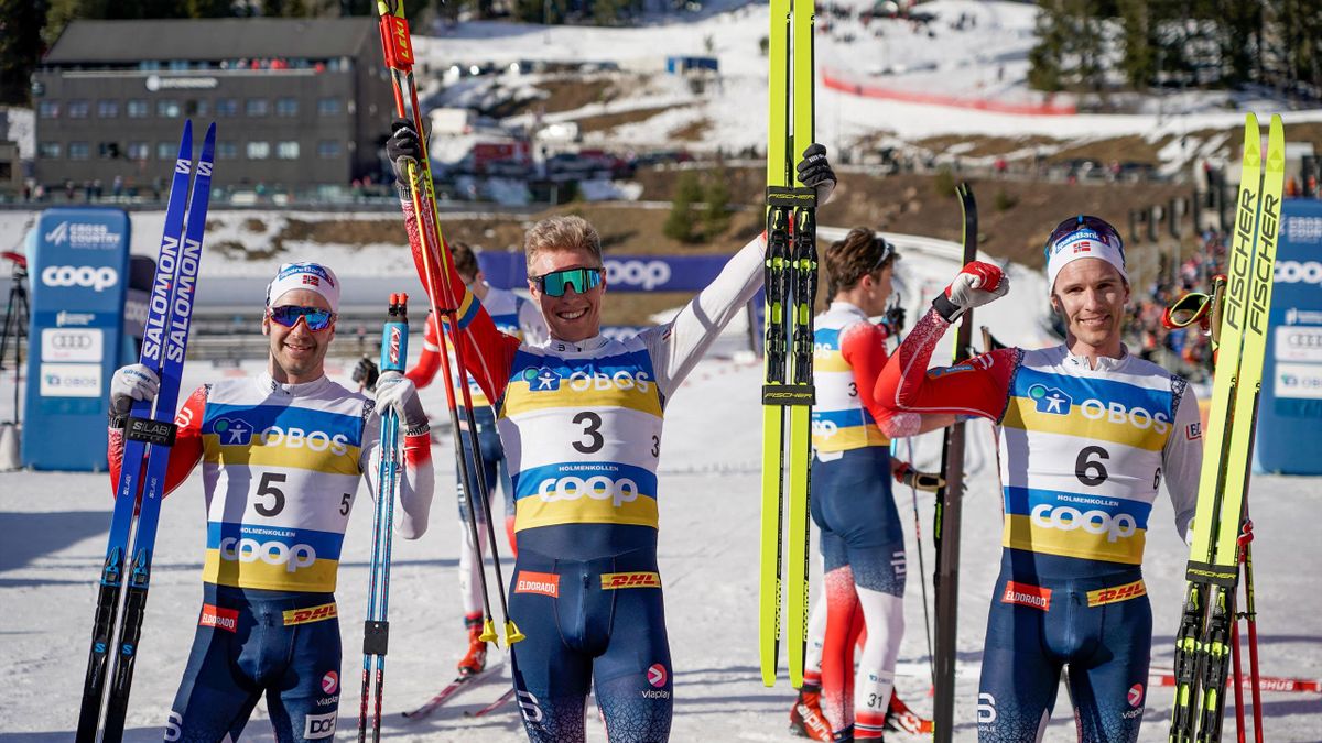 econd placed Norway's Sjur Roethe, winner Norway's Martin Loewstroem Nyenget and third placed Didrik Toenset celebrate after Men's Mass Start 50.0 km Classic during the Holmenkollen ski festival 2022 on March 6, 2022