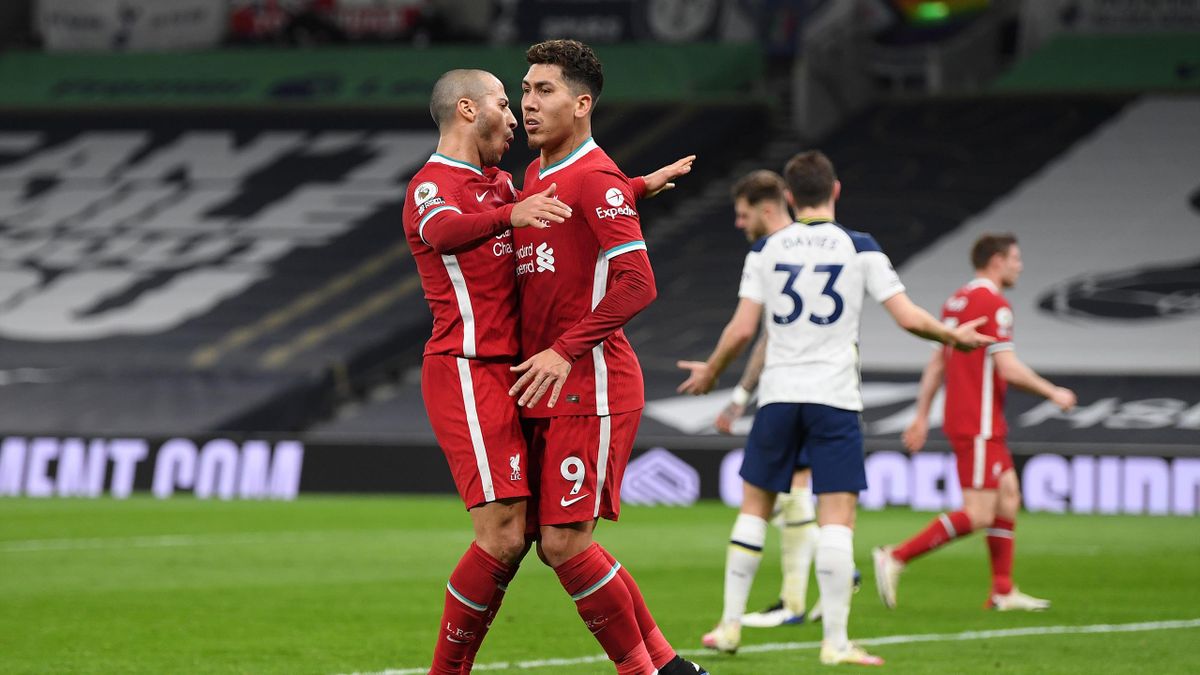 Roberto Firmino of Liverpool (R) celebrates with Thiago Alcantara of Liverpool after scoring his teams first goal during the Premier League match between Tottenham Hotspur and Liverpool at Tottenham Hotspur Stadium