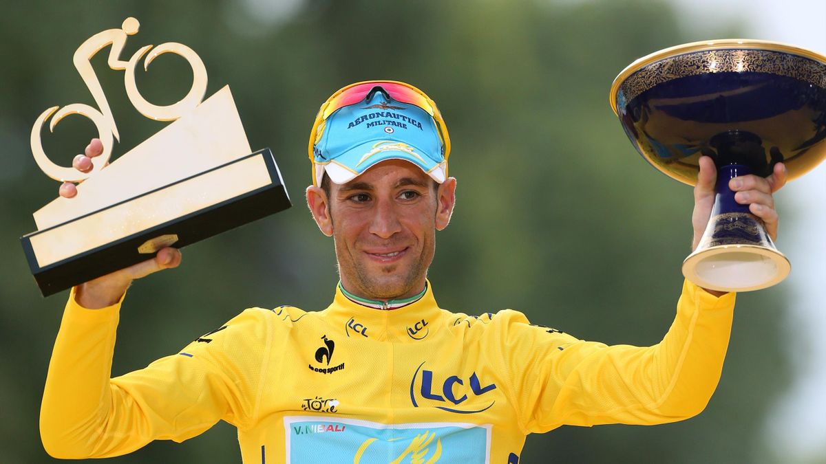 Vincenzo Nibali of Italy and Astana Pro Team celebrates winning the yellow jersey on the podium, following the twenty one and last stage of the 2014 Tour de France, a 134 km individual time trial stage between Evry and the Champs-Elysees in Paris