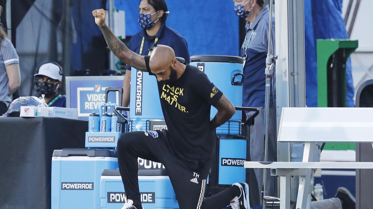 Head coach Thierry Henry of Montreal Impact takes a knee in support of the Black Lives Matter movement