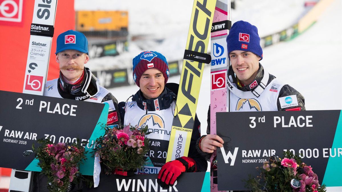 The FIS World Cup RAW AIR overall winner Kamil Stoch from Poland (C) together with 2nd placed Robert Johansson from Norway (L) and Andreas Stjernen from Norway (R) celebrate after the Flying Hill Individual Tournament in Vikersund, Norway, on March 18, 20