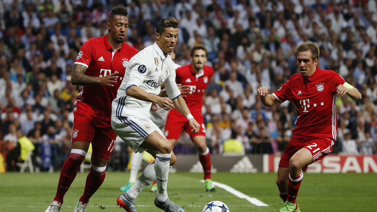 Real Madrid's Cristiano Ronaldo in action with Bayern Munich's Jerome Boateng and Philipp Lahm
