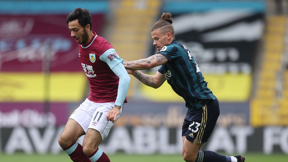 BURNLEY, ENGLAND - MAY 15: Dwight McNeil of Burnley and Kalvin Phillips of Leeds United battle for the ball during the Premier League match between Burnley and Leeds United at Turf Moor on May 15, 2021 in Burnley,
