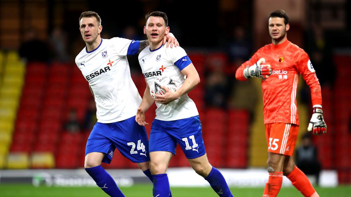 Connor Jennings of Tranmere Rovers celebrates with teammate Peter Clarke after scoring his team's first goal during the FA Cup Third Round match between Watford FC and Tranmere Rovers at Vicarage Road on January 04, 2020 in Watford, England.