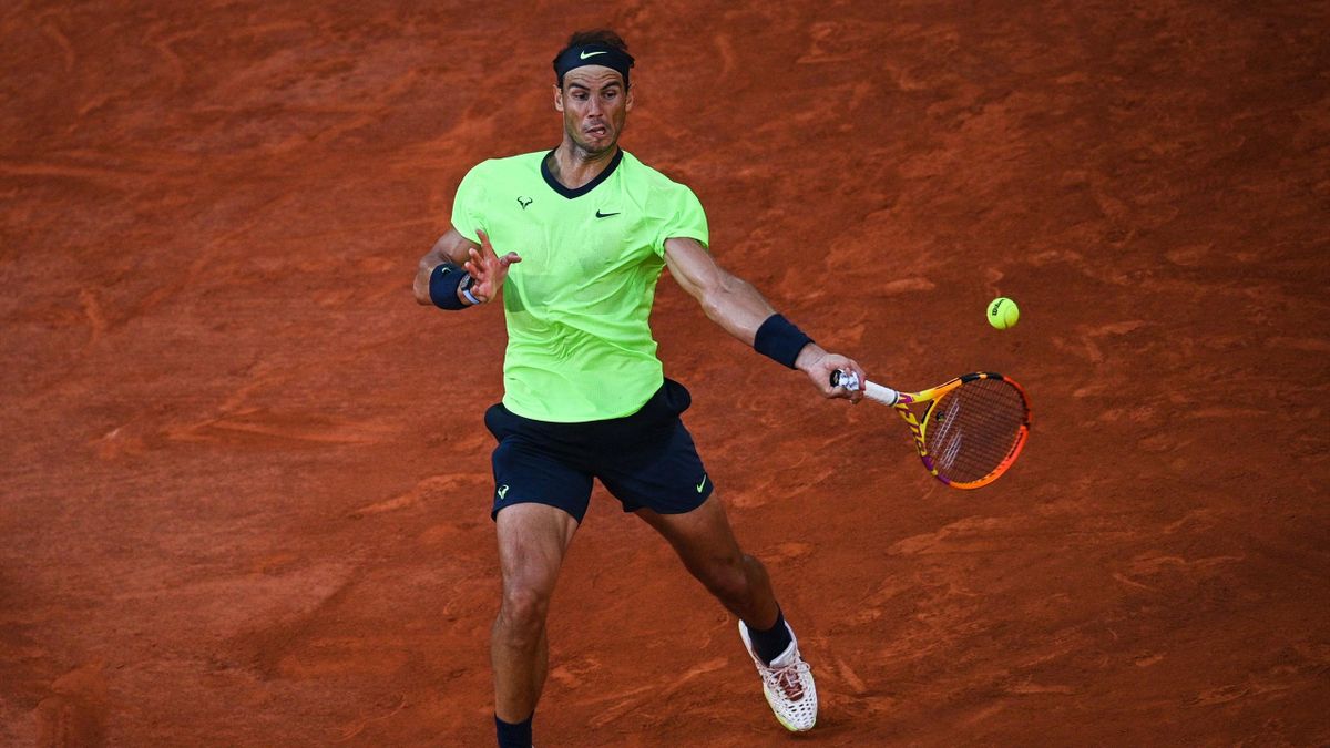 Spain's Rafael Nadal returns the ball to Serbia's Novak Djokovic during their men's singles semi-final tennis match on Day 13 of The Roland Garros 2021 French Open tennis tournament in Paris on June 11, 2021. (Photo by Anne-Christine POUJOULAT / AFP) (Pho