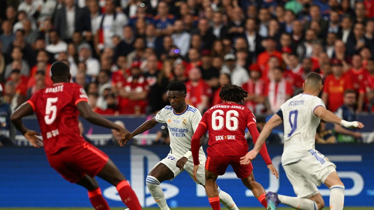 Real Madrid's Brazilian striker Vinicius Junior (2nd L) fights for the ball with Liverpool's French defender Ibrahima Konate (L) and Liverpool's English defender Trent Alexander-Arnold (2nd R) during the UEFA Champions League final football match between
