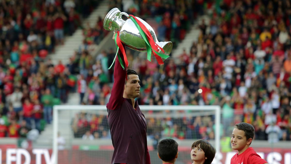 Portugal's Cristiano Ronaldo holds the Euro 2016 championship trophy before the team's match against Sweden.